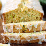 Moist lemon zucchini bread topped with lemon glaze and lemon slices